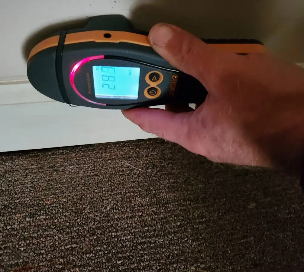 Moisture detection at baseboard during Storm Damage Restoration in Morton